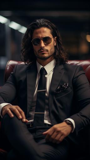 Create a 8K resolution image capturing a business men with sunglasses, black long hair, sitting in his buro, in fornt if the camera looking in the camera. dressed with a suit. The visual quality should emulate a shot from the world's top Canon camera --ar 9:16