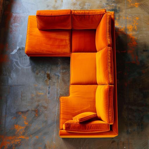 an orange L-shaped couch in a sparsely furnished room, photographed from directly above