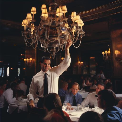 The Challenge Before Slang Scene Setting: A bright and busy full-service restaurant during peak lunchtime. Large chandeliers diffuse soft light onto the bustling dining area. Waitstaff navigate skillfully among tables, attending to guests. Main Focus: Front and center, a young hostess at a marble-topped stand juggles a tablet, greeting guests, and a continuously ringing classic telephone. Guest's Perspective: In the midst of awaiting patrons, a sophisticated woman tries calling the restaurant, a hint of exasperation on her face as she hears the engaged tone, while looking toward the incessantly ringing phone on the hostess's stand.