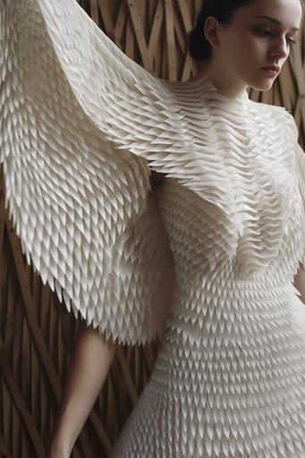 Texture sleeves they look like wings shape in degradee of texture in a jumpsuit. The model is beautiful. The space neutral