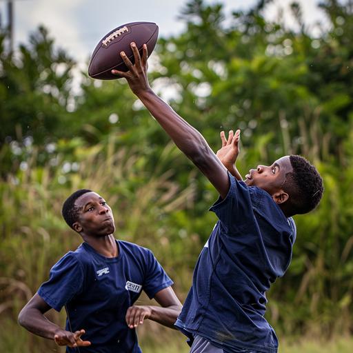 Black teen boy catching a football over another black teen boy, they are both wearing Navy Blue t-shirts and Navy blue shorts, photo realistic, natural lighting s750, dslr camera