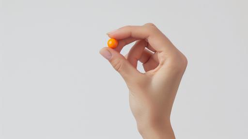 straight on shot, womans hand holding a small orange round pill between thumb and pointer fingers, white background --ar 16:9 --v 6.0