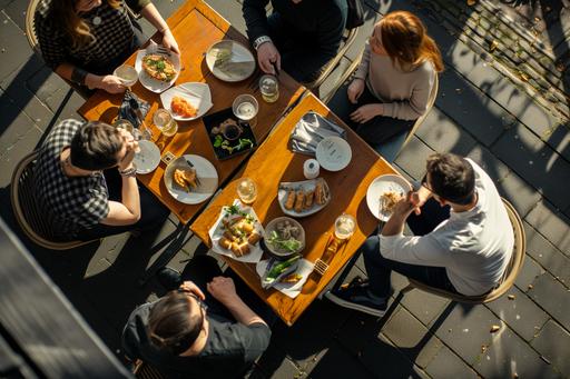 Capture a high-angle, realistic photograph of 5 people enjoying a sunny day on a outdoor restaurant terrace in Amsterdam, The scene should feature individuals with beer glasses, sharing plates of Japanese fingerfood: Yakitori, duck springrolls, spicy harumaki, gyoza, kara age, tatsuta, Emphasize the vibrant atmosphere, ensuring the composition feels genuine and inviting, 35mm FUJIFILM Style, --ar 3:2 --v 6.0