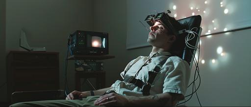 a man is sitting in a chair, his wrists are strapped to the armrest, ECG electrodes are strapped on his chest, EEG electrodes are strapped on his head, his eyes are streched open with tweezers, HE IS SLEEPING WITH HIS EYES OPEN, a projector is next to him projecting on a wall, he's watching the projections, dark, cinematic, moody, hyper realistic --ar 7:3