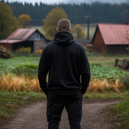 A 40-year-old man wearing an all - black hoodie, back view, rustic farm background, photo taken with nikon d750