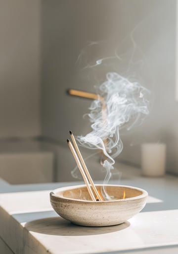 A photo of burning palo sartre sticks in an elegant ceramic bowl on top of the sink, natural light, neutral colors, white background, aesthetic, instagram post style --ar 7:10