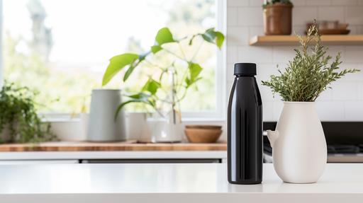 A realistic photograph captures a kitchen bathed in white tones. On a pristine marble countertop, a sleek, black insulated water bottle with a wide mouth, 32 oz in capacity, stands tall. In the background, a houseplant adds a touch of greenery to the scene. Nestled beside the bottle, three oranges add a vibrant pop of color. The dimensions of the bottle, 27 cm in height and 9.5 cm in width, are proportionate to both the oranges and the kitchen setting. The bottle boasts a seamless, monochromatic design without any logos, blending effortlessly into the serene ambiance of the white-themed kitchen. --ar 16:9