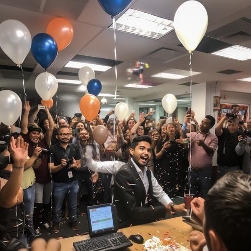 happy birthay party in newsroom with balloons and cake shaped like the city of austin, tx. There are a mixture of white, black and hispanic people clapping for the birthday boy. the picture is from the view of the birthday celebrant