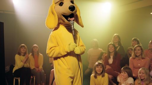 Bill Patterson is a man in a furry cute yellow dog costume with long droopy ears and a long scarf around his neck entertaining children for a kids TV show, sneaking up behind the audience, 1975, vintage, 70's style photorealistic --ar 16:9