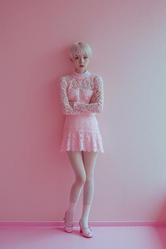 Fashion photo, skinny girl all goddess image, strong discomfort, pink dress with short skirt, arms folded, short hair, Japanese , white net tights, pink shoes, blond hair, in front of pink wall, looking at camera, standing on right edge of screen, ZEISS Supreme Shot with Prime lens, 8K --ar 2:3 --v 6.0 --style raw