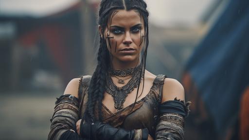 Full length image, beautiful viking warrior woman with black braided hair, in viking figure hugging sheer tribal, hands behind her back leaning forward towards the camera, full length photo, low camera point of view facing subject, intricate details, beautiful symmetrical features, HDR, beautifully shot, hyperrealistic, sharp focus, 64 megapixels, perfect composition, high contrast, cinematic, atmospheric, dynamic lighting back lit, soft flame light, global illumination, fire torch light, dramatic light, mountain sunset in background, --ar 16:9 --q 2 --q 2 --v 5.1