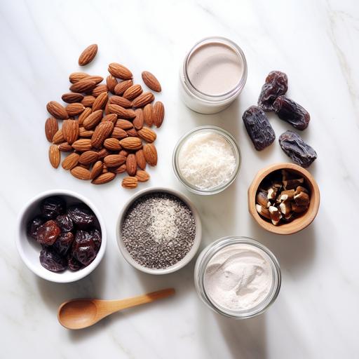 INGREDIENTS laid out on white background - COCONUT, PEANUT BUTTER, DATES, ALMOND MYLK, CHIA SEEDS, PECANS, CACAO, RAW LOCAL HONEY, VANILLA, CHIA SEEDS, CELTIC SALT