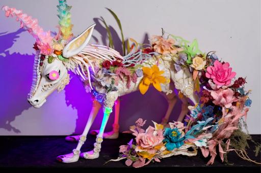 plastic goat skeleton made of pastel colored flowers, five cokrouch flying, a greyhound, plastic flowers interstate garden, a train, a toy robot, cut from Katsuhito Ishii 