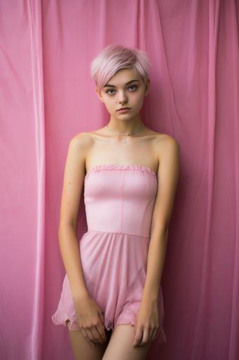 Portrait photograph, 17-year-old girl, Head to toe fits in the screen,short pink dress, arms folded in front of pink wall, extremely thin, full body image, short hair, half Japanese, half Italian, green eyes, blonde hair, staring into camera, taken with ZEISS Supreme Prime lens,8k --ar 2:3 --v 5.2 --style raw