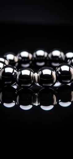 a black and silver bead bracelet, in the style of smooth and shiny, dark atmosphere, paleocore, heavy shading, dark black, imitated material --ar 59:128