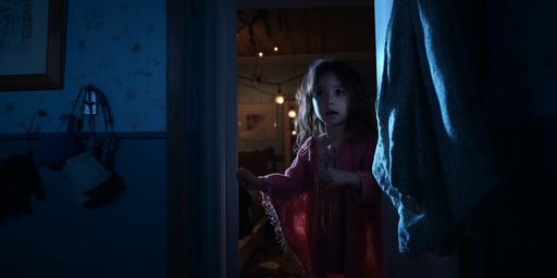 a still from a movie, full-body, POV shot, a baby girl is pushing open the door to her parents' room, she is wearing pijamas and holding a blanket, nighttime, nightlight, dark --style raw --ar 2:1 --no cartoon