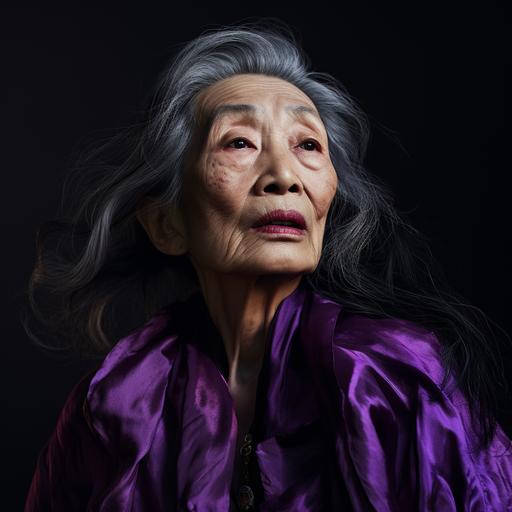 an editorial style hyper realistic photograph with harsh shadows. Shoulders up portrait of an old beautiful wrinkled asian woman with long styled hair, purple eyeshadow, strange facial expression looking up into the distance. Proportions a bit off and grotesque.