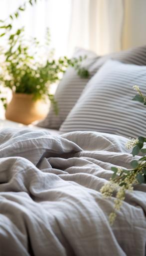 close-up of the finely striped heather gray fabric of a fluffy down duvet placed on a bed in a modern, cozy bedroom interior. soft and bright daylight, touch of rattan, natural materials, plant --ar 4:7