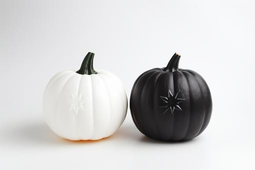 halloween decorations for halloween with black pumpkin and white pumpkin top view in white background , --ar 3:2