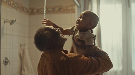 indoor photography, a black grandpa is holding his grandson in the air, they are laughing in the bathroom in the morning, white light, cozy, realistic skin, realistic, modern, style raw --ar 16:9 --v 6.0