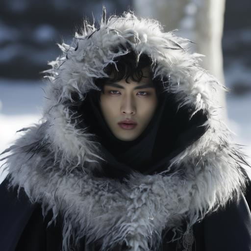 kdrama still of a young man wearing a stone mask that covers the top half of his face, a white fur hood, 2 bell necklaces, and a black robe with white fur trimming over a blue longsleeved turtleneck