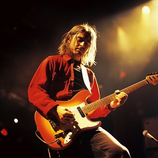 kurt cobain artistically playing a red electric guitar on stage
