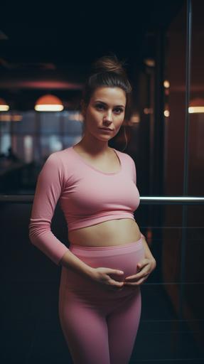 medium shot of pregnant woman, big belly, wearing pink gym clothes, in a city modern gym, dark atmosphere with pink soft led lights, brunette, dark eyes, pixie modern hair, hipster and modern style, nose piercing, shot in 2023 in the style of Vivian Maier. candid::3 30mm lens, shot in 2023. candid, minimalism, moody, modern, cinematic realism, Eye Level Shot, shot with hasselblad 30mm, Kodak Ektar 100::1 , --ar 9:16