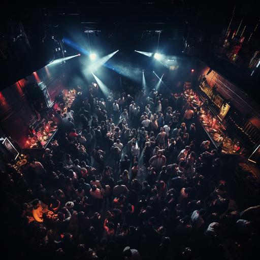 packed nightclub. Photo is taken from bird’s eye view looking directly down into a sea of people. No space is without a person. Dark colored