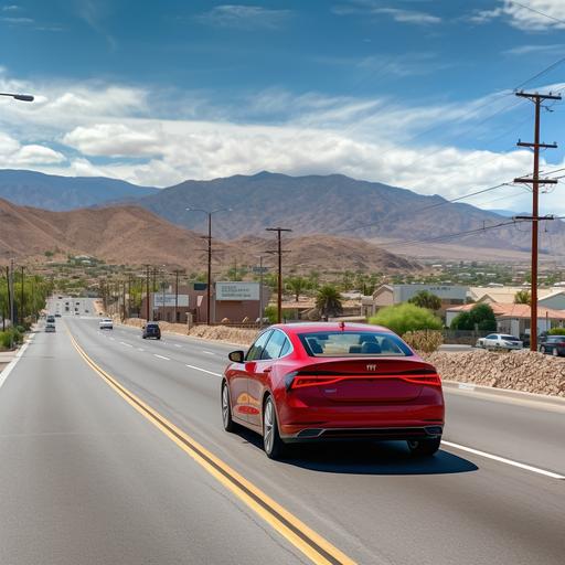photo of a 2022 red sedan viewed from behind, driving towards a small American town visible off in the distance, there is a billboard on the right side of the road, there are mountains in the background, it is day time and the sky is blue with some clouds