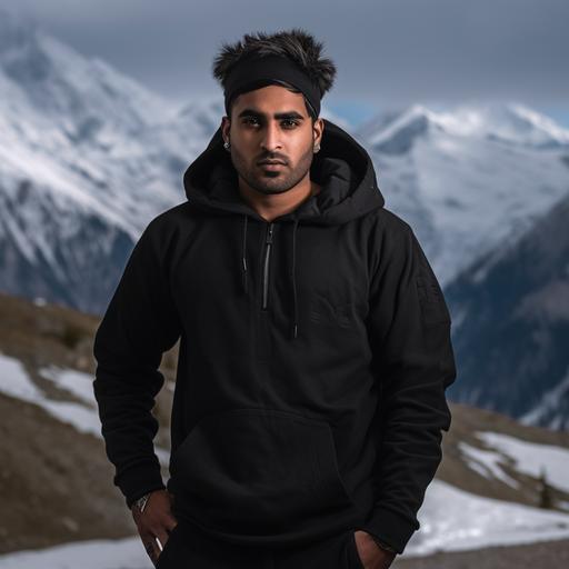 photoshoot of a 6 feet tall Indian man wearing high quality, plain black hoodie in military fatigue. The hoodie should have no chains. Background is in the snow capped mountains.