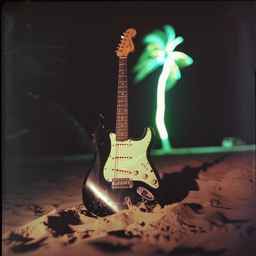 realistic photo of a black fender Stratocaster with a black pickguard and rosewood fretboard standing upright in the sand at a beach at night with no light except it is reflecting the light from a neon green palm tree sign that is out of the camera image