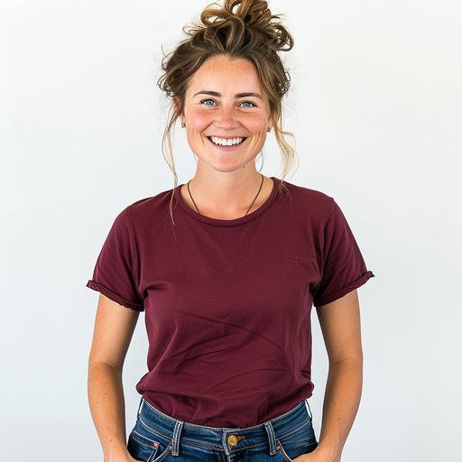 white woman wearing a loose fitting dark red t-shirt and jeans, she is smiling, her hair is up, white background